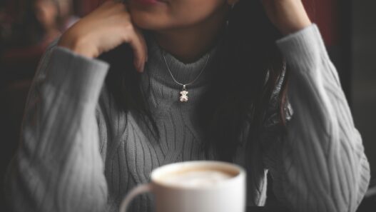 cup of coffee in front of woman