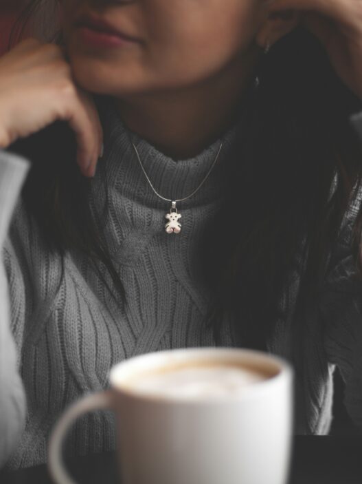 cup of coffee in front of woman