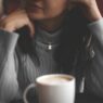 cup of coffee in front of woman
